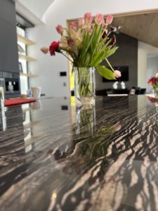 Sureshine technician applying MORE® AntiEtch® to protect a marble countertop in a Corona del Mar home.