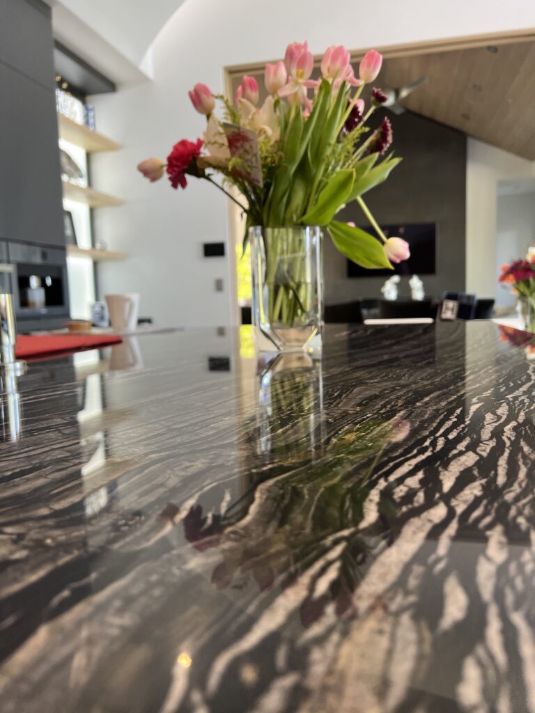 Sureshine technician applying MORE® AntiEtch® to protect a marble countertop in a Corona del Mar home.