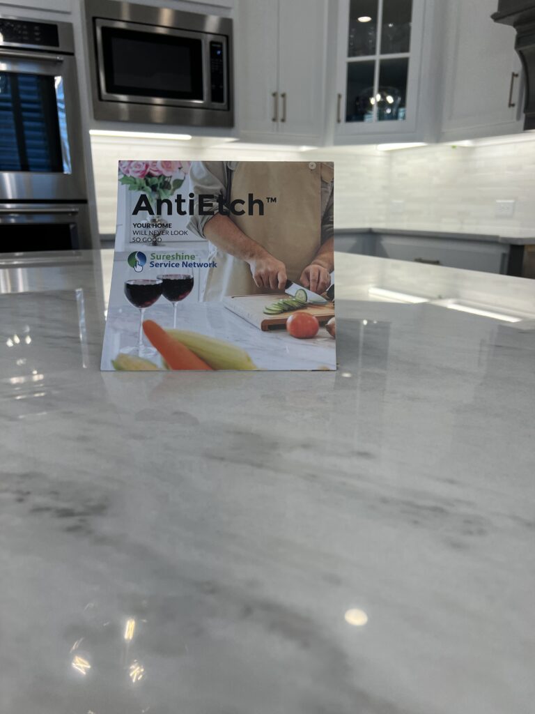 Technician applying MORE® AntiEtch® to a marble countertop in a Laguna Niguel home kitchen to prevent etching and staining.