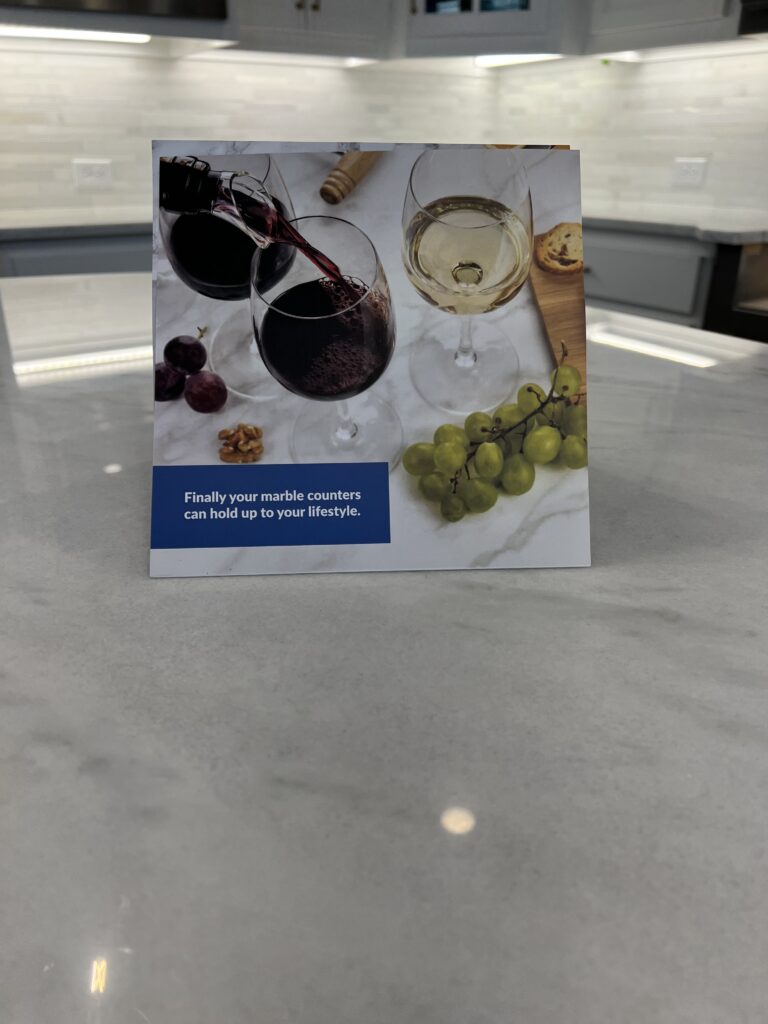 A polished marble countertop in a Newport Coast kitchen protected with MORE® AntiEtch®, showing clear veining and a natural satin finish.