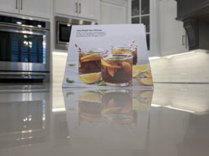 Crystal-clear MORE® AntiEtch® protection applied to a marble kitchen island in Westlake, TX — showing a perfectly smooth, natural finish with no visible etching or staining.