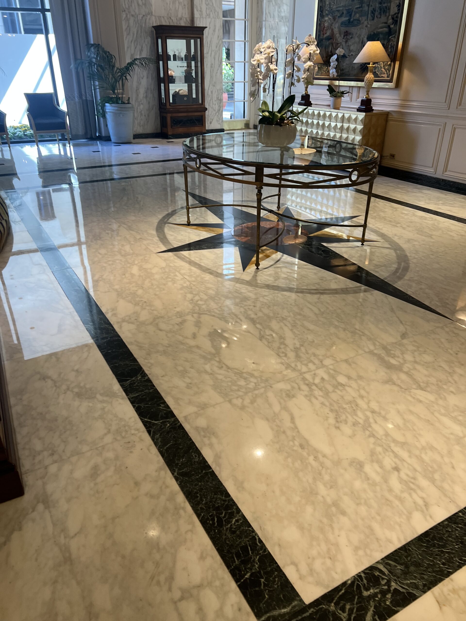 Technician honing and polishing a marble floor to restore smoothness, clarity, and reflection as part of a professional marble restoration service.