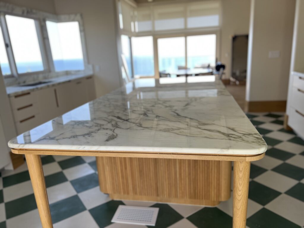 Technician refinishing a marble floor in a Laguna Beach home, restoring shine and clarity to a high-traffic area