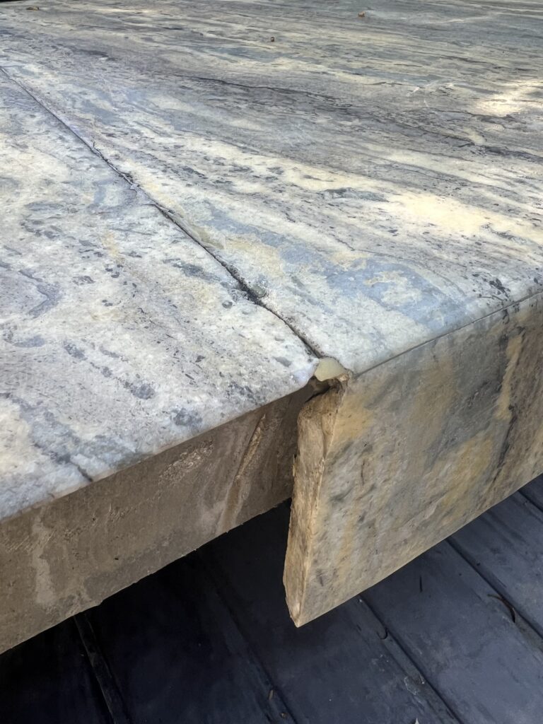 Close-up of granite sink rail crack being professionally repaired by Sureshine technician in a Laguna Beach kitchen.