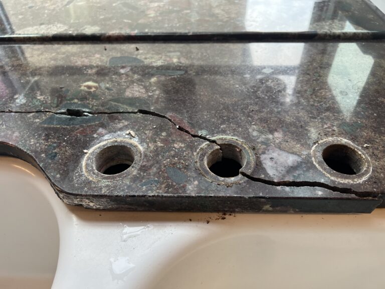 Technician performing granite crack repair on a kitchen countertop in Pasadena home using professional tools.