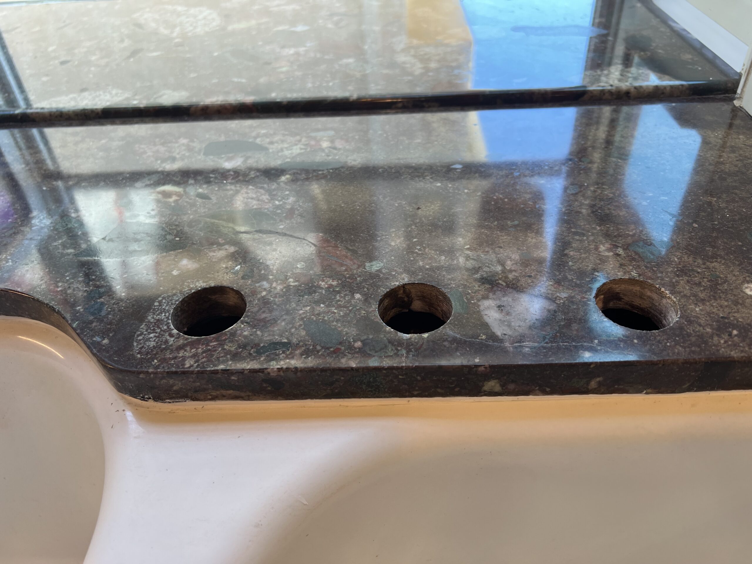 Cracked granite countertop before and after repair in a Manhattan Beach kitchen, restored by Sureshine Care and Restoration Services, Inc.