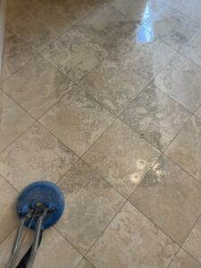 Technician deep-cleaning and polishing a travertine floor in a residential Studio City home, restoring the natural finish.