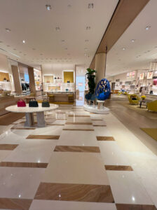 Polished limestone and onyx floor in a retail store, finished by Sureshine for a luxurious, high-gloss appearance