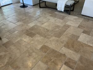 Textured travertine floor after a deep cleaning by Sureshine, revealing a refreshed and natural finish