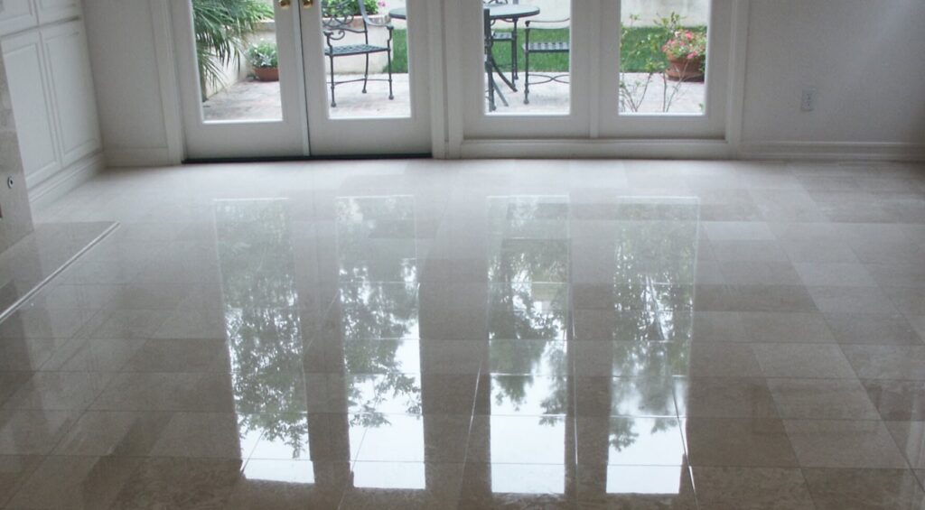 Technician polishing a marble floor in a luxury Pacific Palisades home using professional stone restoration equipment