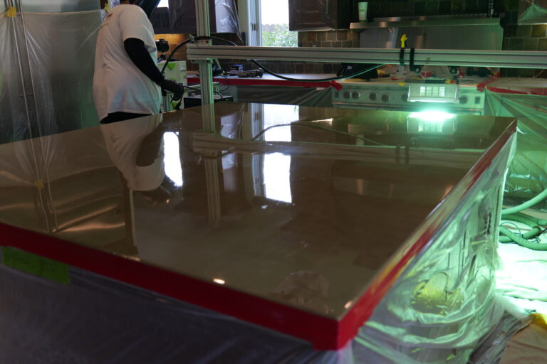 A marble countertop undergoing the AntiEtch® curing process, using UV light technology to create a durable, stain-resistant, and etch-proof surface.