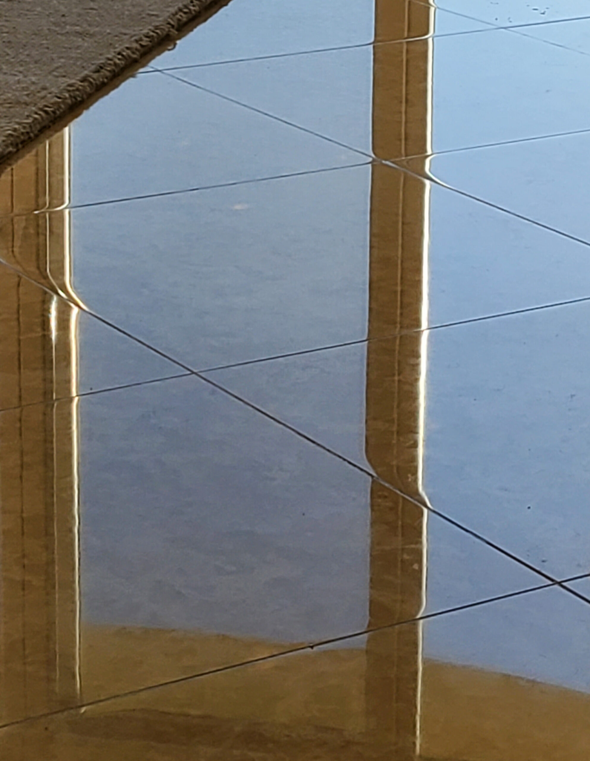 Polished marble floor in a Corona Del Mar home reflecting natural light after professional marble restoration by Sureshine Care and Restoration Services.