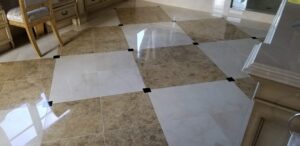 Technician polishing a marble floor in a luxury Plano home, restoring its high gloss finish