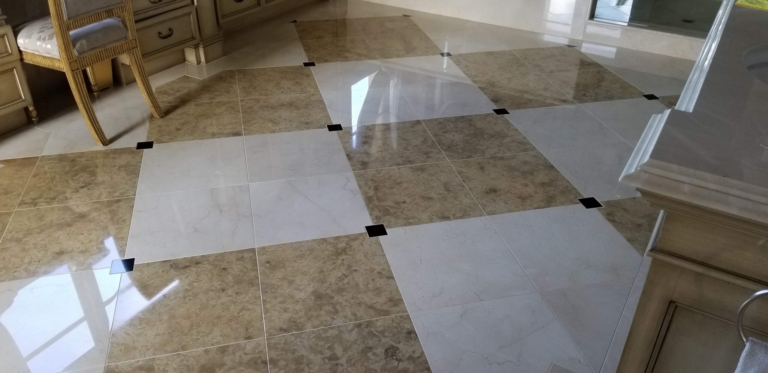 Technician polishing a marble floor in a luxury Plano home, restoring its high gloss finish