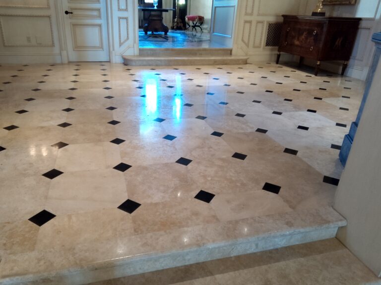 Before and after photo of a polished travertine floor restored by Sureshine in a Laguna Niguel home, showing the transformation from dull and pitted to smooth and reflective.