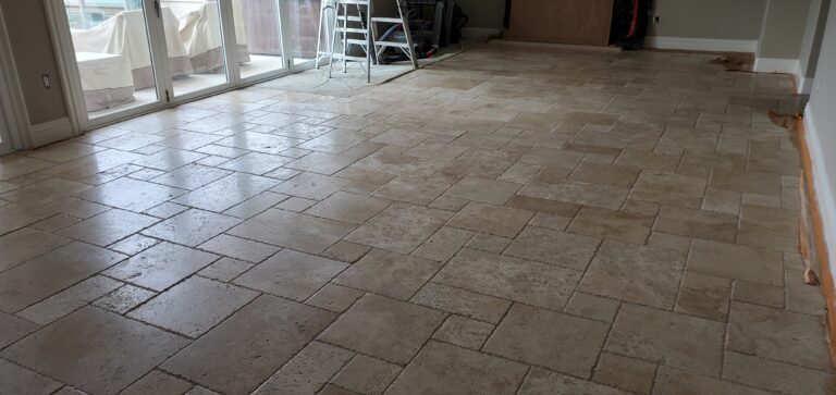 Sureshine technician polishing travertine floors in a Frisco, TX home to restore smoothness and natural shine.