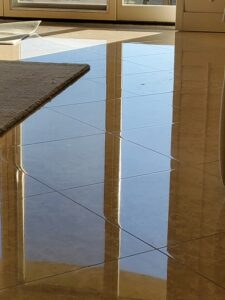 Sureshine technician polishing a marble bathroom vanity in a Sherman Oaks home, restoring its shine and removing etches