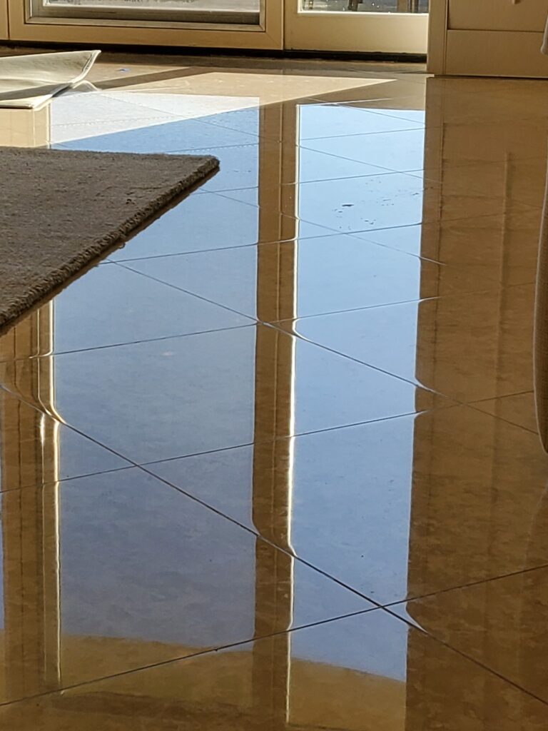 Sureshine technician polishing a marble bathroom vanity in a Sherman Oaks home, restoring its shine and removing etches