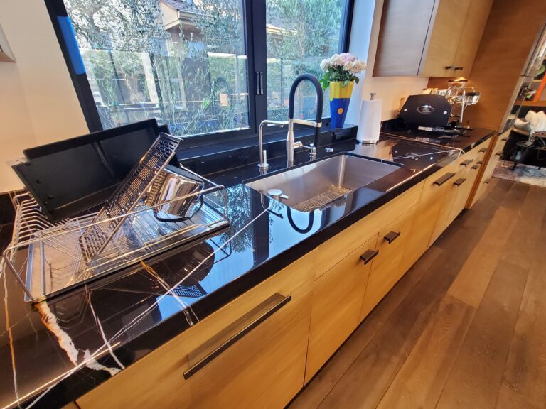 Polished marble countertop in a Las Colinas kitchen reflecting natural light after expert restoration by Sureshine