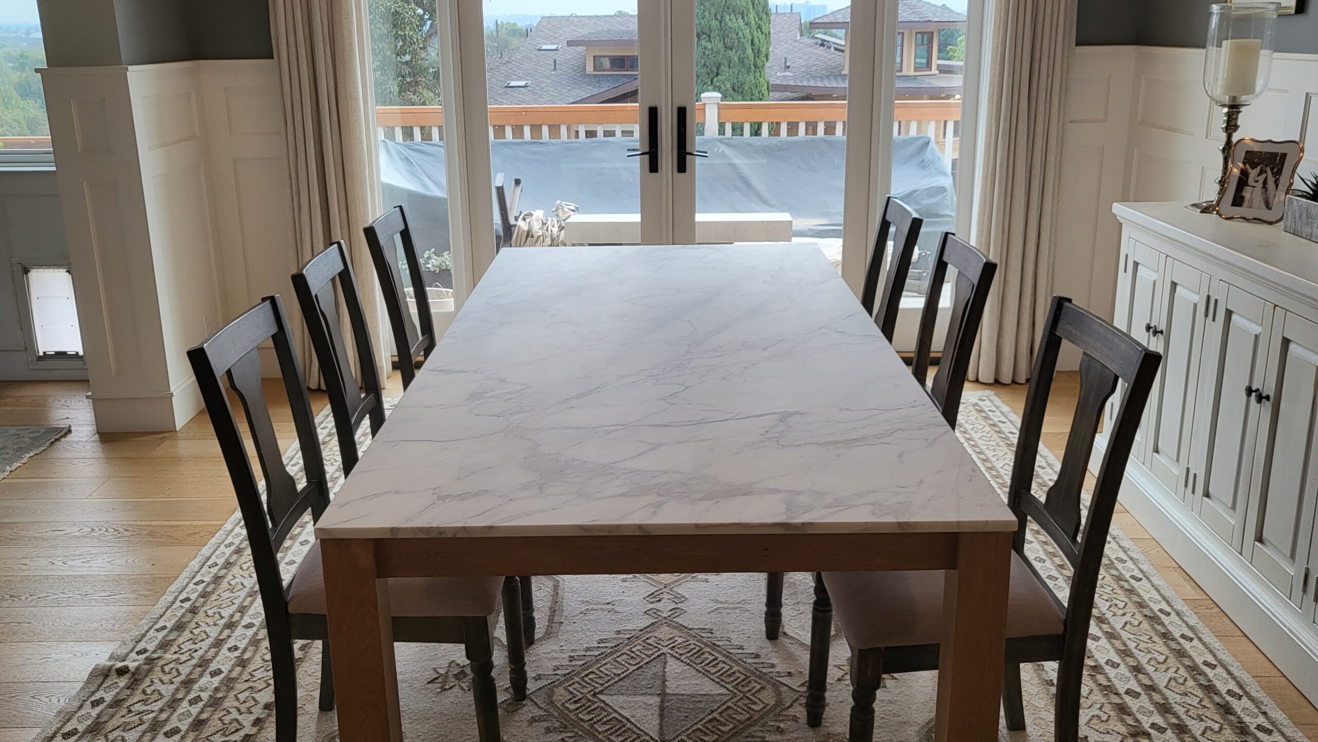 Technician polishing marble floors in a Beverly Hills home to restore a glossy finish using professional stone restoration equipment by Sureshine.