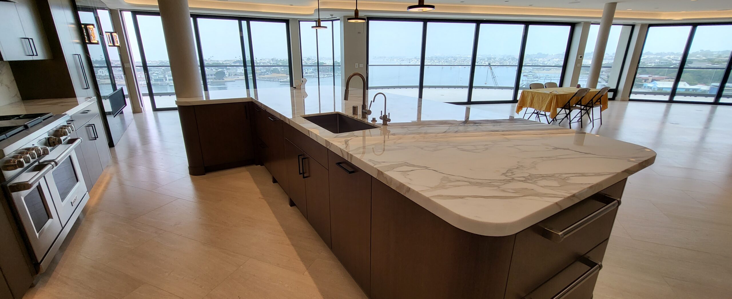 A luxury marble kitchen countertop in a Malibu home protected with MORE® AntiEtch®, reflecting natural light with a smooth, polished finish.