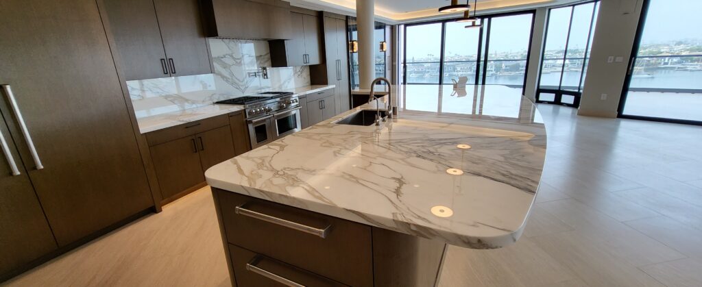 Sureshine technician applying MORE® AntiEtch® to a marble kitchen countertop in Plano, TX