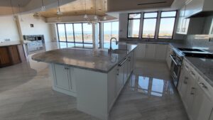 Marble floor refinished and polished by Sureshine Care and Restoration Services, Inc. in a Newport Beach home, showing restored shine and enhanced natural veining.