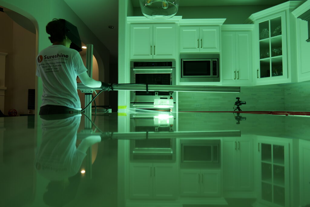 Technician applying MORE® AntiEtch® to a marble vanity in a Beverly Hills bathroom