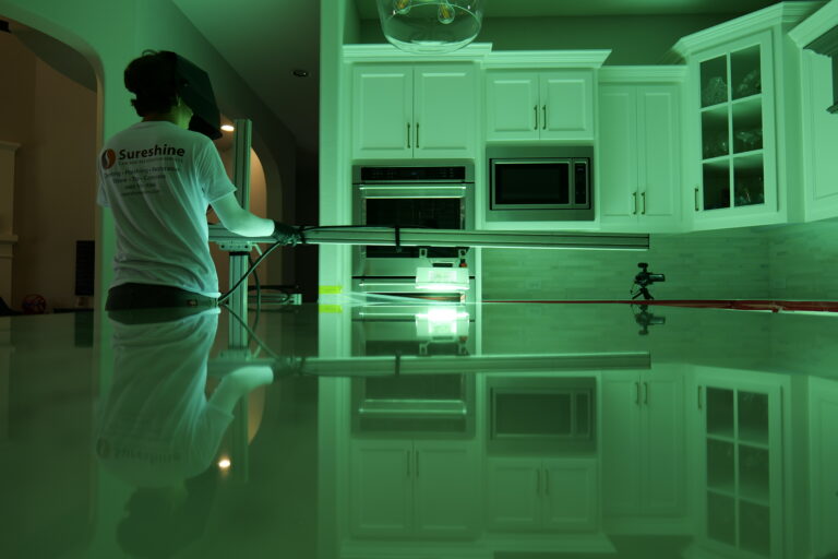 Technician applying MORE® AntiEtch® to a marble vanity in a Beverly Hills bathroom