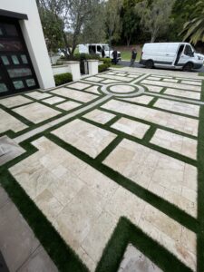 Technician performing professional travertine cleaning and restoration on a stone floor, removing embedded dirt from pores and grout lines with specialized extraction equipment.