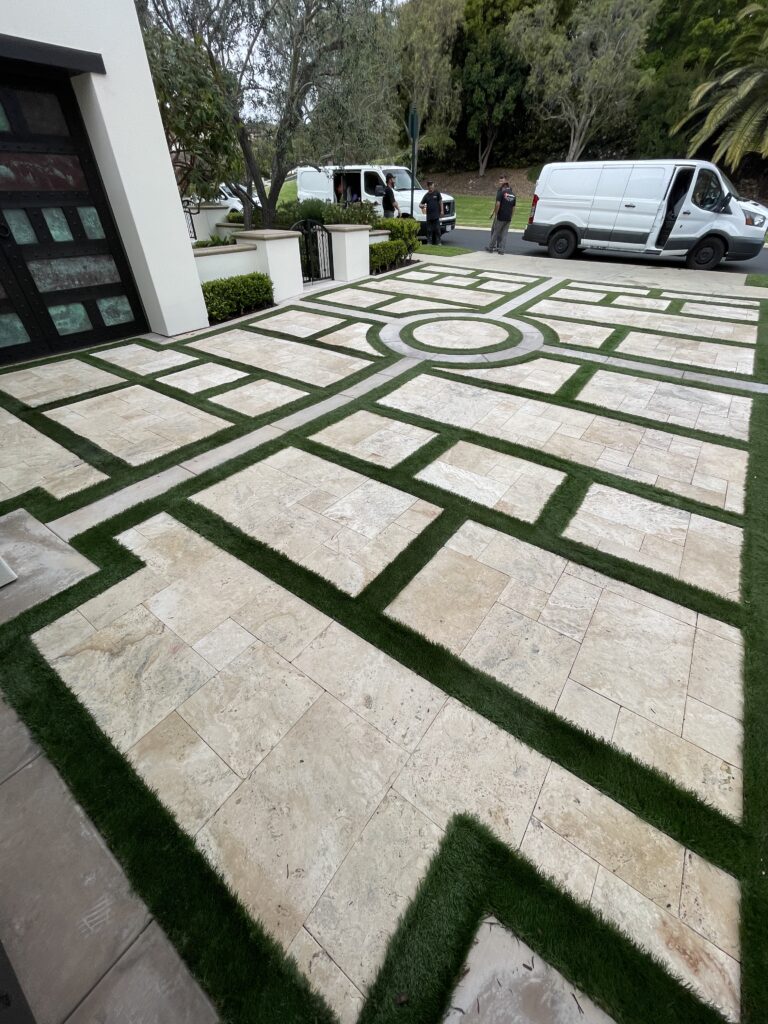 Technician performing professional travertine cleaning and restoration on a stone floor, removing embedded dirt from pores and grout lines with specialized extraction equipment.