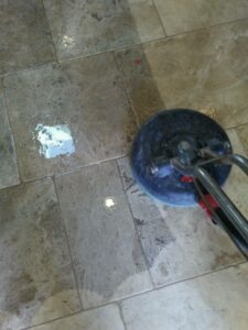 Technician polishing limestone flooring in a Southlake, TX home to restore shine and smoothness.