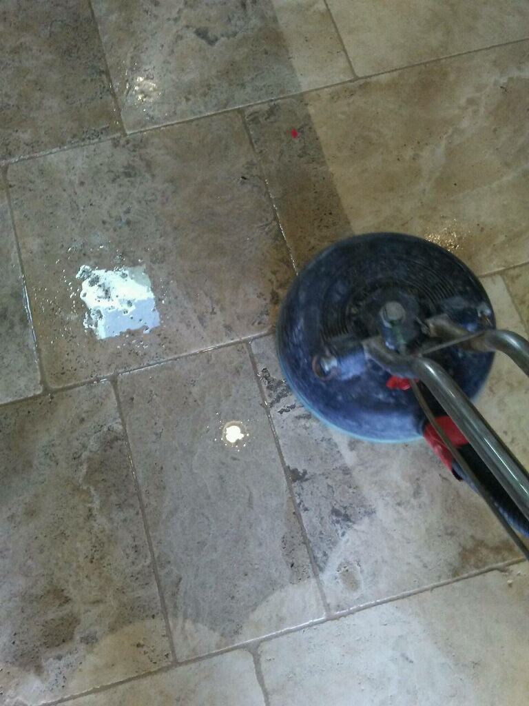Technician polishing limestone flooring in a Southlake, TX home to restore shine and smoothness.