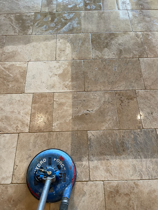 Clean, sealed travertine flooring in a Plano, TX living room, restored to a bright and smooth finish by Sureshine Care and Restoration Services, Inc.