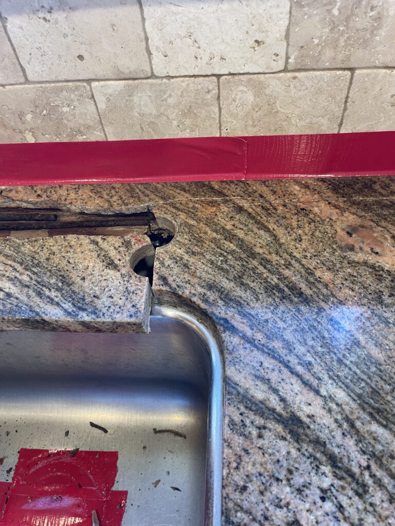 Repaired granite countertop in a Beverly Hills kitchen showing seamless restoration of a front sink rail crack by Sureshine