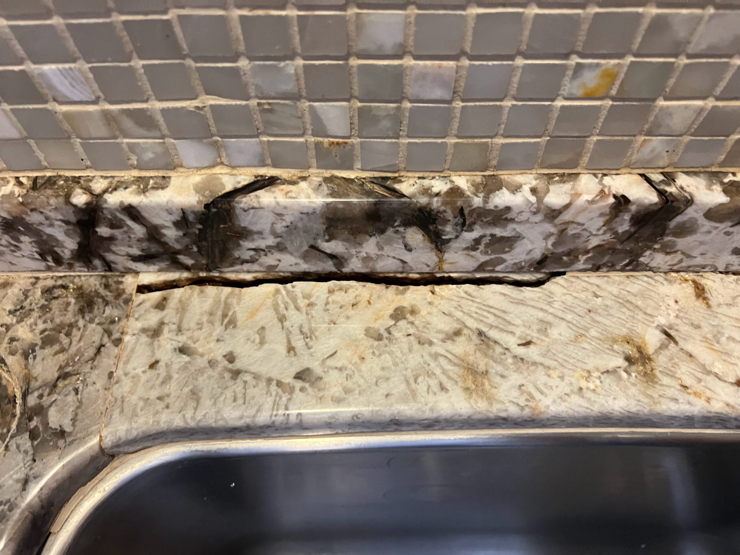 Repaired granite countertop in Highland Park, TX with seamless sink rail crack repair and polished finish by Sureshine.