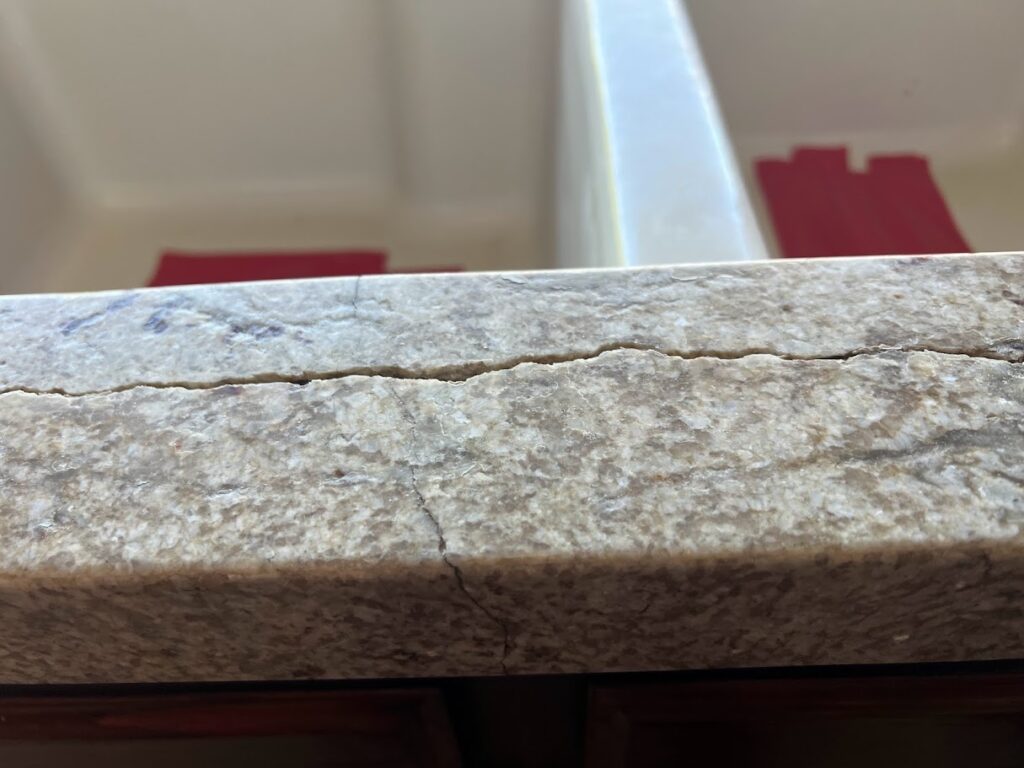 Close-up of a granite countertop being repaired near the sink rail in a luxury Westlake, TX kitchen