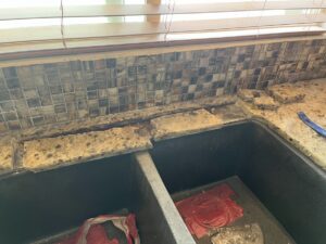 Granite countertop in Newport Beach with a restored crack near the sink, polished to a seamless finish by Sureshine technicians.