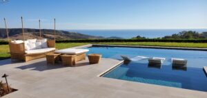 Before and after professional exterior natural stone cleaning in Laguna Beach California showing restored travertine color and removed surface buildup.