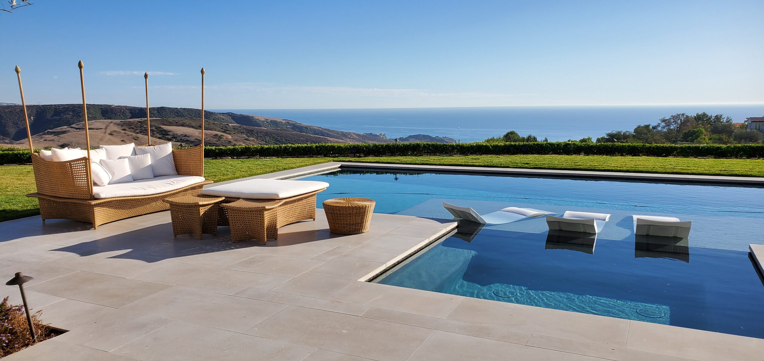 Before and after professional exterior natural stone cleaning in Laguna Beach California showing restored travertine color and removed surface buildup.