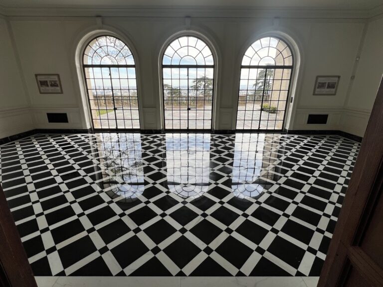 Technician honing and polishing a marble surface to remove etch marks and scratches, restoring a smooth finish with clear reflection and an even sheen.