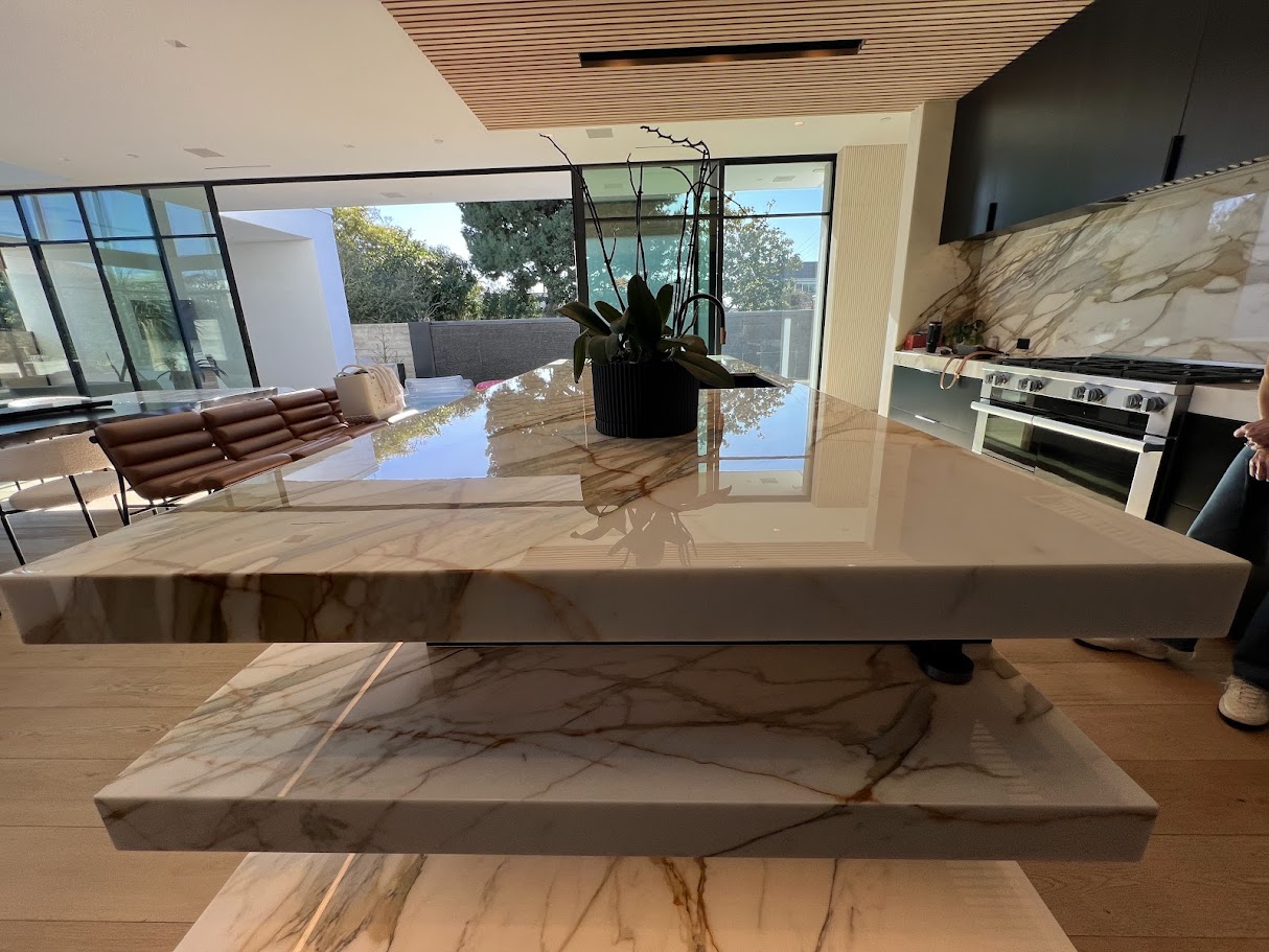 Before and after professional marble floor restoration in a Pacific Palisades California home showing improved clarity, consistency, and reflection.