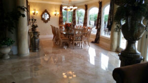 Before and after professional travertine floor cleaning and restoration in a Newport Beach California home showing cleaner grout and restored stone.